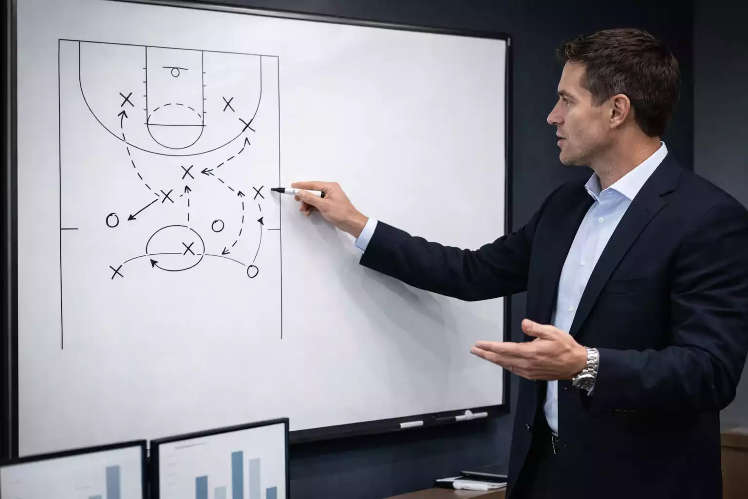 Basketball coach explaining strategy with whiteboard diagram
